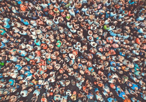 Aerial. People crowd background. Mass gathering of many people. Top view. Toned.