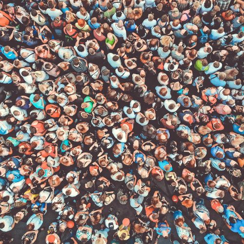 Aerial. People crowd background. Mass gathering of many people. Top view. Toned.